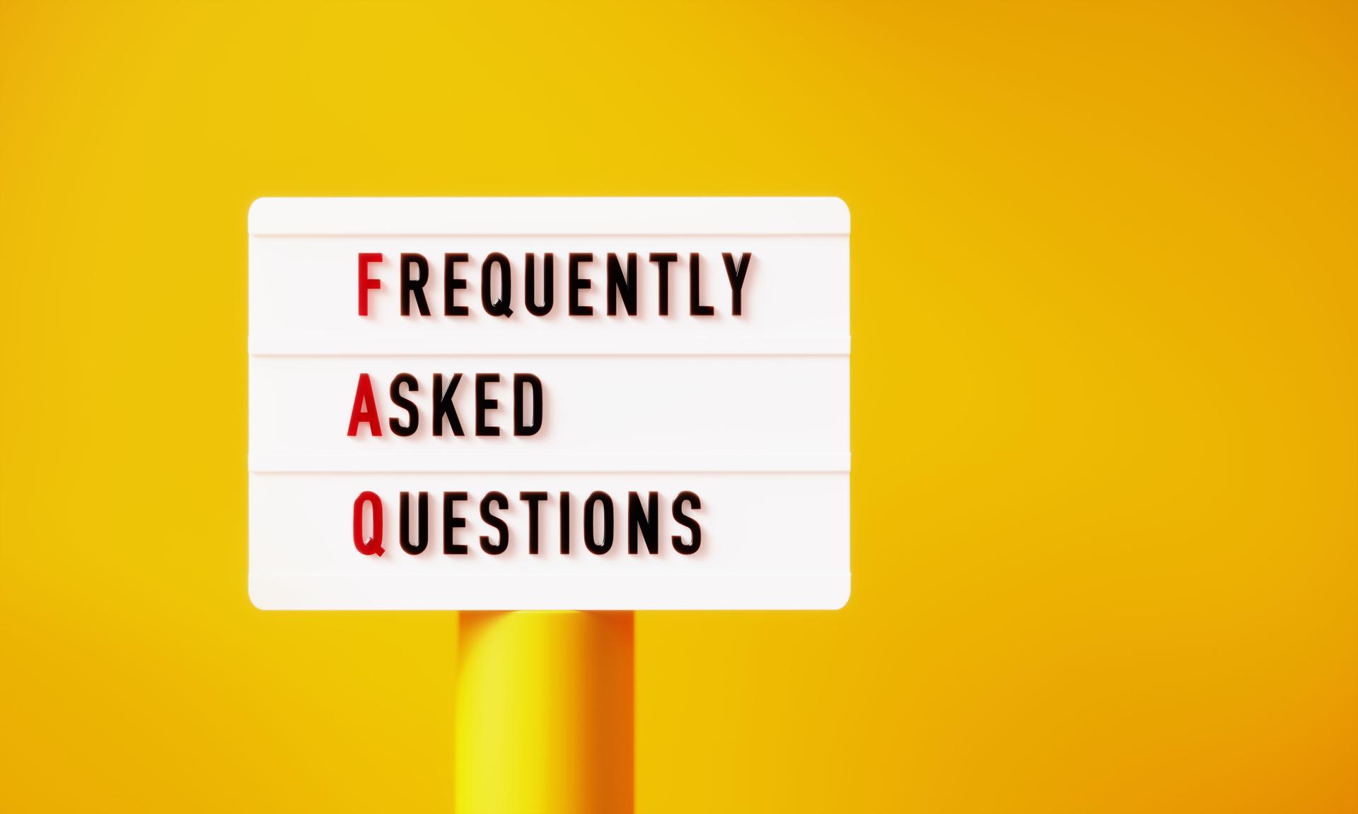 FAQ Written White Lightbox On Yellow Podium Before Yellow Background